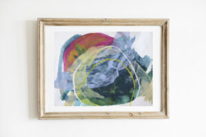 Colorful, abstract mixed media artwork in a light wood frame