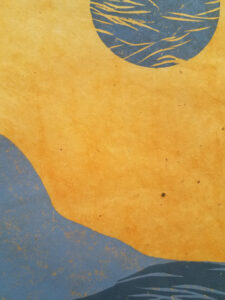 Detail of a woodcut print of an abstracted landscape with a moon above. The print is in shades of gray on orange paper.