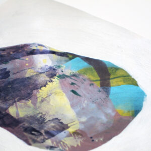 Detail of a mixed media painting of a single rock surrounded by white. The bottom edge of the paper is bordered by blue paint, which appears to splash upward on the left side.