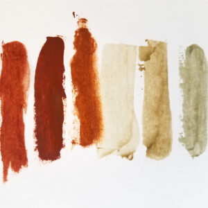 swatches of handmade oil paint in shades of red and green